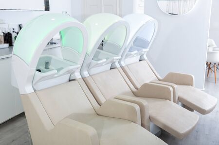 Empty massaging chairs for washing hair in european beauty salonの写真素材