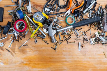 Different hand tools and fasteners on wooden surface. Home repair concept. Copyspaceの写真素材