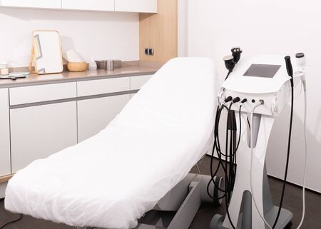 Light interior of modern aesthetic cosmetolody clinic with chair for patient and equipment for cosmetic proceduresの写真素材