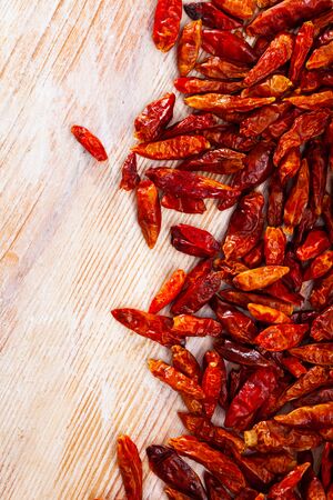 Hot red cayenne pepper on a wooden tableの写真素材