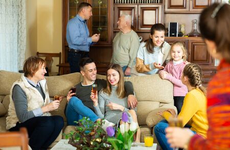 Big family with grandparents and children spending time together at homeの写真素材