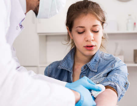 Doctor injecting teenage girlの写真素材