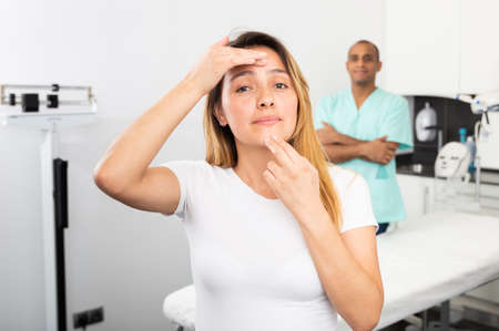 Woman satisfied with results of cosmetology procedures in clinicの写真素材