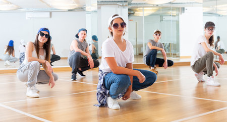 Happy girls and boy dancing hip hop