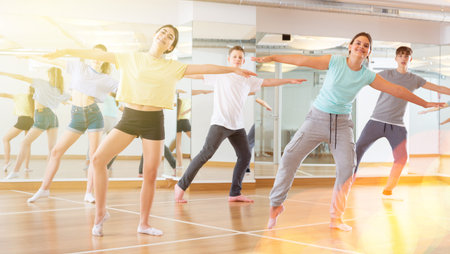 Teenagers in dance hall studying new movements