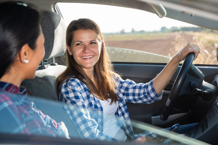Latino and caucasian women travelling by car