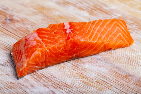 Fresh raw salmon fillet on wooden table