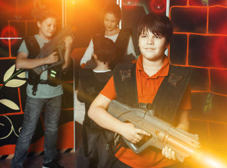 Portrait of smiling boy standing with laser gunの写真素材