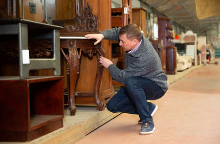 Man chooses new furniture for home in the storeの写真素材