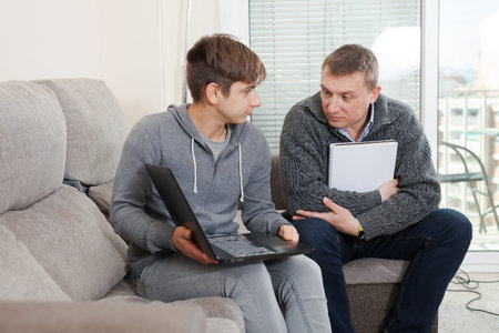 Father helping son to do homework