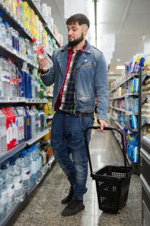 male choosing water in bottlesの写真素材