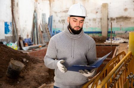 Engineer planning renovation works at building site