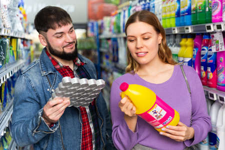 pair choosing household detergentsの写真素材