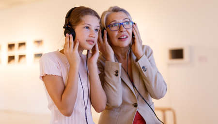 People using audio guide in museumの写真素材