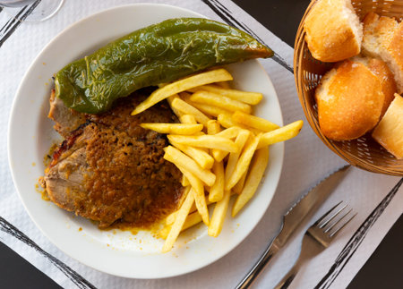 Close up of tasty fried pork with french fries