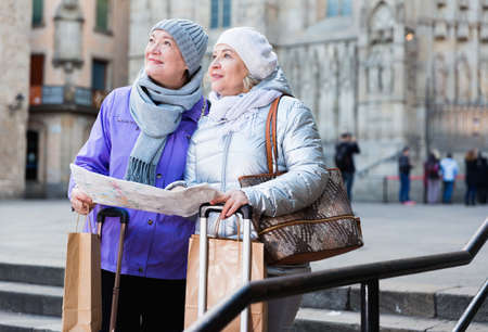 Mature ladies travellers with mapの写真素材