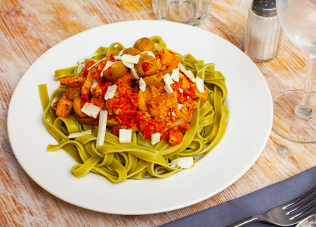 Italian spinach tagliatelle pasta with tomato sauceの写真素材