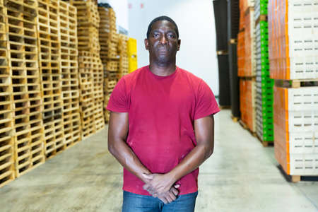 Portrait of afro american with arms crossed at warehouse of fruit packing factoryの写真素材