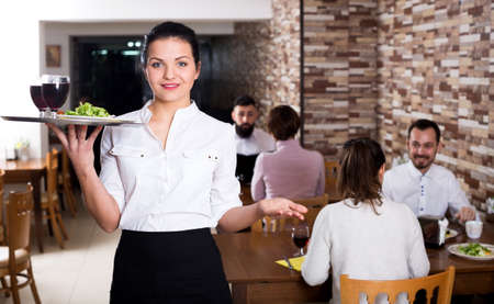 Female waiter showing country restaurantの写真素材