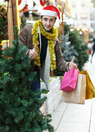 Man expression happinnes from buying decoration at Christmas fairの写真素材