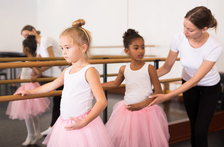 Ballet trainer teaching two little girls