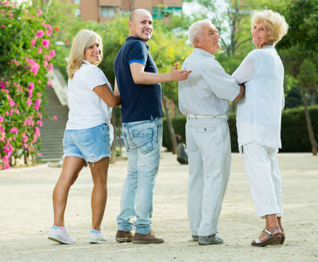 elderly friends are walking in the parkの写真素材