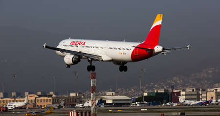 Airline Iberia plane comes in for a landing in an aeroport El Prat city of Barcelonaのeditorial素材
