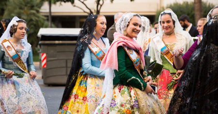 People in national costumes walking through streets