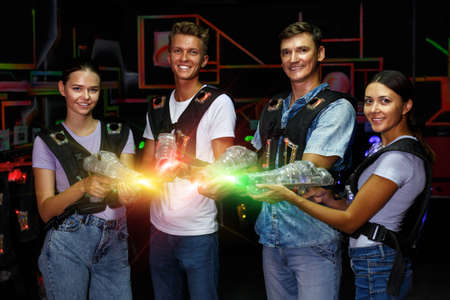 Group portrait of young people with laser guns having fun togethの写真素材