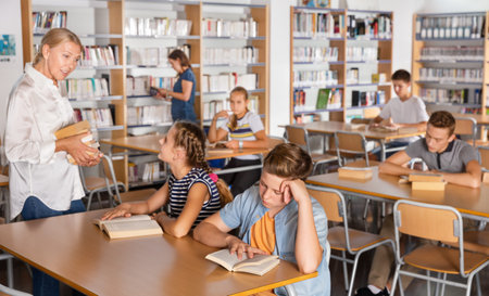 Upset boy and girl sitting with books during lesson