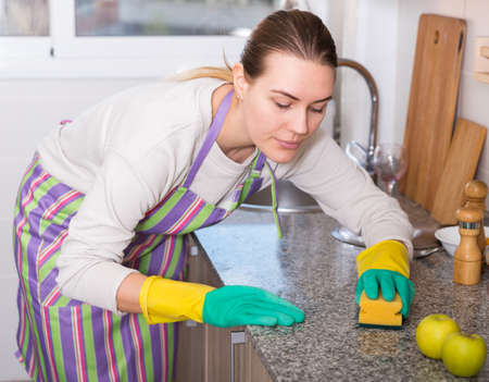 Female is caring about clean of kitchenの写真素材