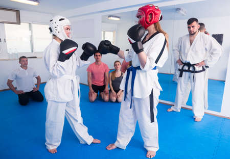 Girls are sparring in pair to use taekwondo techniqueの写真素材