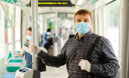 Man in medical mask riding city bus