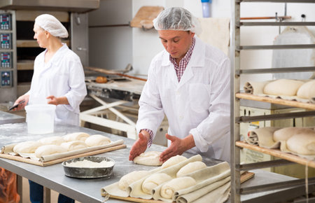 Baker forming dough for baking bread