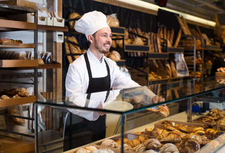 Professional baker is offering fresh tasty croissant