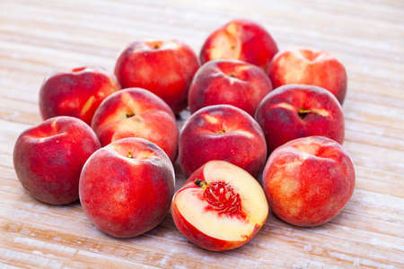Juicy ripe peaches on wooden tableの写真素材