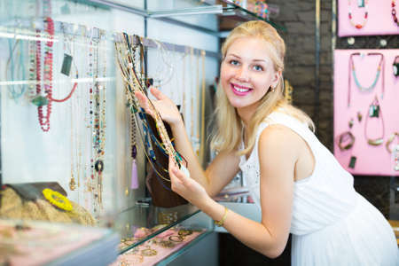 girl customer choosing necklace.の写真素材