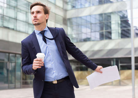 Portrait of busy man in suit rushingの写真素材