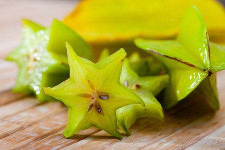 Carambola fruit on wooden table closeup