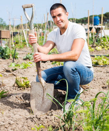 Man professional horticulturist with garden shovel at landの写真素材
