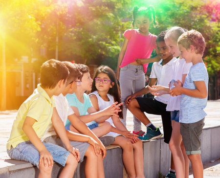 Eight children are talking about play on walk in the park