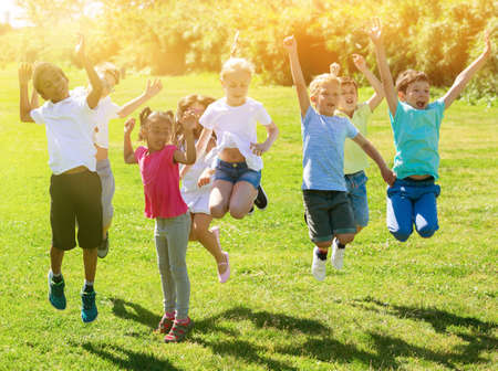 Group of happy children jumping and smiling togetherの写真素材