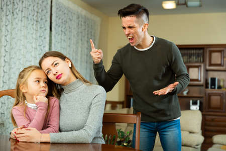 Couple quarreling in presence of daughterの写真素材