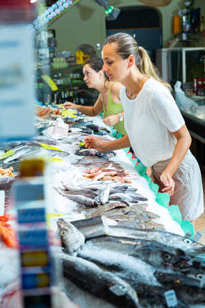 Buyers searching for seafoods in shopの写真素材