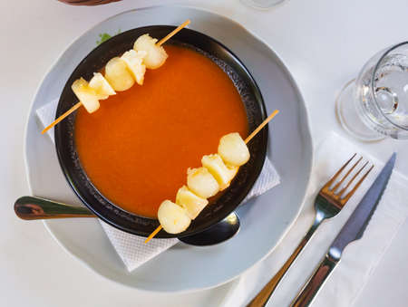 Spanish gazpacho tomato soup with melon slices on skewersの写真素材