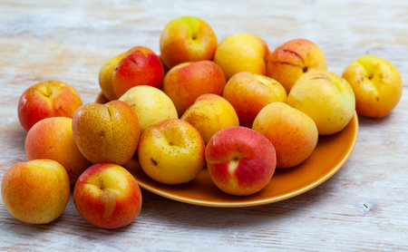 Fresh ripe apricots on wooden table