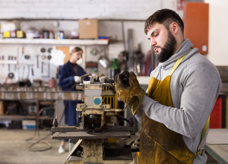 Craftsman working on drilling machine