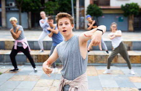 Confident teenager street dancer performing with groupの写真素材