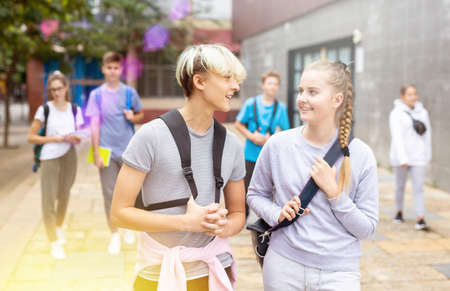 Two teenage students going to college on autumn dayの写真素材