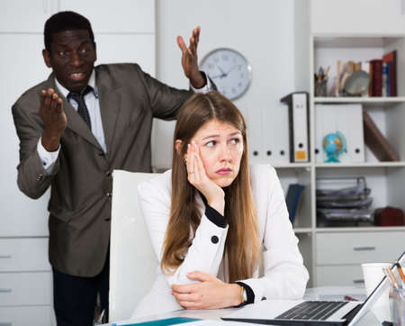 Upset woman with angry bossの写真素材